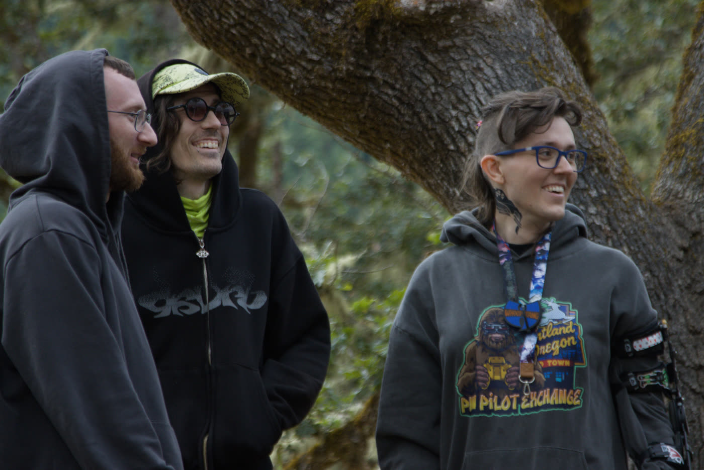 Three club members in club hoodies at a pilot exchange